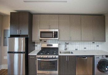 A kitchen with stainless steel appliances and wooden cabinets